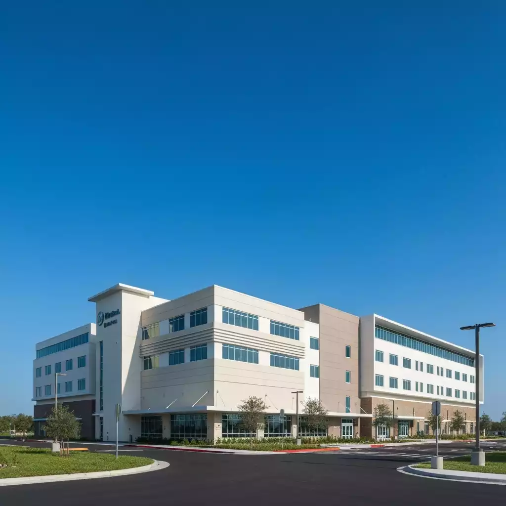 Modern hospital building exterior in Fort Myers, Florida, with clear blue sky