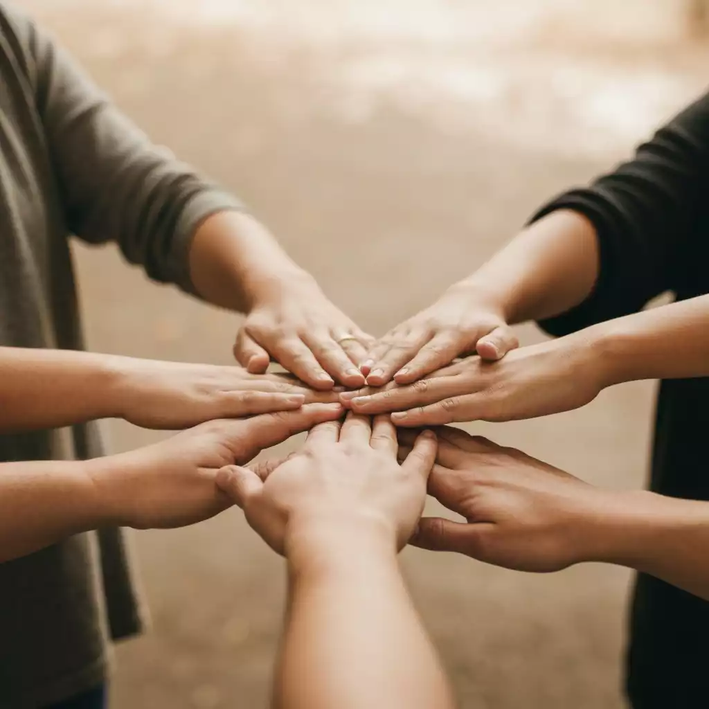 Diverse hands reaching towards each other in a gesture of community support