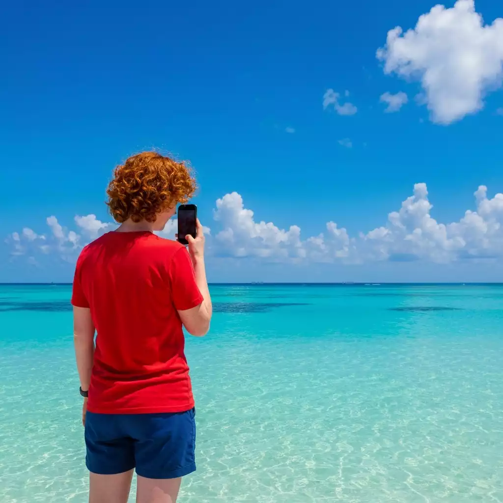 Person checking weather forecast on a smartphone with a beach background in Fort Myers